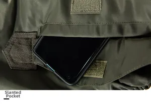 Detail of army green MA-1 flight jacket slanted pocket with Velcro and smartphone storage