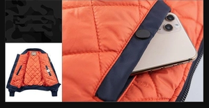 Detail of navy blue bomber jacket showing orange quilted lining and inner phone pocket