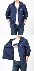 Detail of dark blue men's sun protection jacket with outdoor logo and zipper pockets