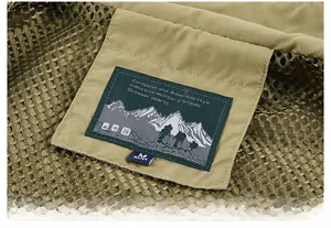 Detail of the outdoor vest collar label with mountain logo and mesh fabric texture