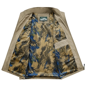 Detail view of khaki outdoor vest showing camo mesh lining and inner zipper pocket
