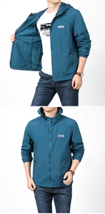Detail of blue men's sun protection jacket with hood, zipper pockets and outdoor logo