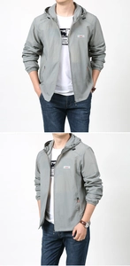 Detail view of men's grey lightweight hooded sun protection jacket with outdoor lettering