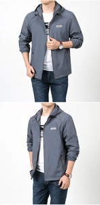 Detail of grey hooded sun protection jacket with elastic cuffs and outdoor lettering