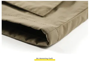 Detail shot of khaki outdoor vest hem featuring durable double-stitch seam and twill fabric