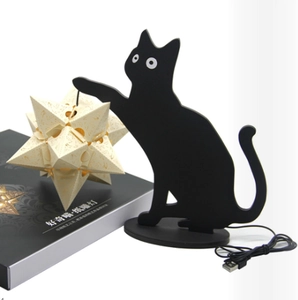 Detail of black cat paper-cut lamp with laser-cut star sphere and USB cable in box