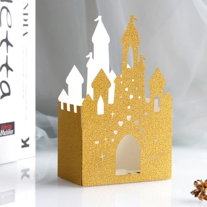 Golden glitter castle candy box with intricate hollow heart and star pattern cutouts