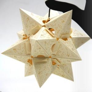Moravian star hanging lamp with intricate laser-cut hollow patterns in cream white