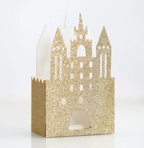 Close-up of golden glitter castle-shaped favor box with intricate hollow details