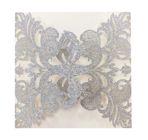 Silver laser-cut square wedding invitation sleeve with floral lace pattern and glitter