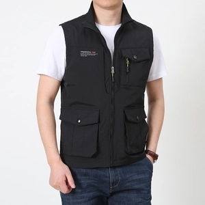 Detail of black tactical vest featuring a stand collar and four large functional pockets