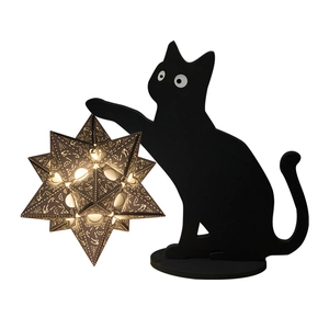 Detailed laser-cut black cat statue holding a glowing star lamp with hollow patterns