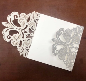 Elegant laser-cut wedding invitation with silver glitter floral pattern and white card