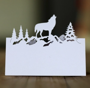 Carte de table en papier kraft découpée au laser avec motif de sapin et loup hurlant