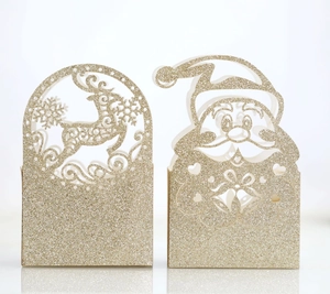 Close-up of glittery hollow laser-cut reindeer and Santa candy gift box packaging