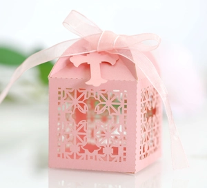 Pink laser-cut cross wedding candy box with elegant ribbon bow for party favors