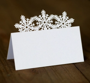 Macro view of white snowflake place card made of glitter pearlescent paper for winter weddings