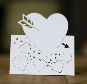 Laser cut white heart table card with arrow and 3D folding design for weddings
