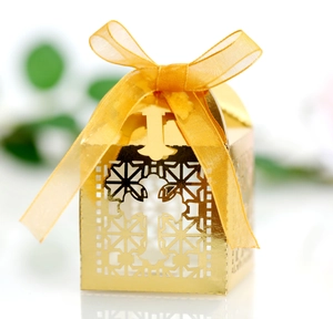 Elegant gold laser-cut favor box with cross pattern and ribbon for weddings