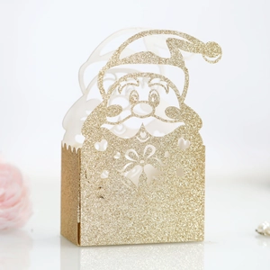 Close-up of golden glitter Santa Claus hollow gift box with laser-cut holiday details