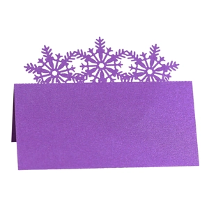 Detail of purple glitter place card with laser-cut snowflake design for tables