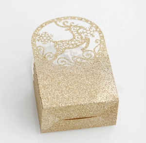 Close-up of glitter gold hollow laser-cut reindeer and snowflake festive gift box