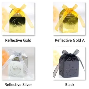Laser cut star and moon pattern candy boxes in gold, silver, and black with ribbon bows