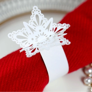Laser-cut white paper snowflake napkin rings for Christmas festive table decoration