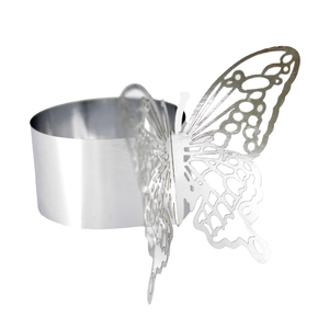 Macro view of silver butterfly napkin ring featuring intricate hollowed-out metal design