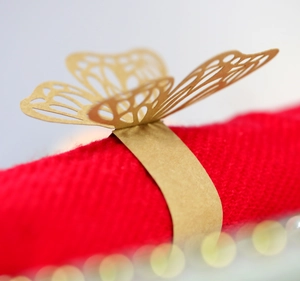 Detailed laser-cut gold butterfly napkin ring holder for elegant wedding table decor