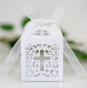 Laser cut white cross favor box with sheer ribbon for weddings and religious parties