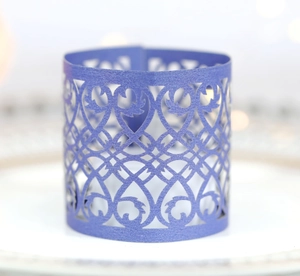 Macro view of purple laser-cut paper decorative wrap with intricate floral patterns