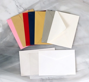 Macro detail of various colorful craft envelopes arranged on marble with v-flap closure