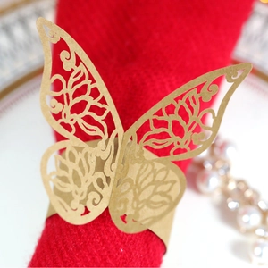 Elegant gold hollow butterfly napkin ring with laser-cut floral texture for wedding decor