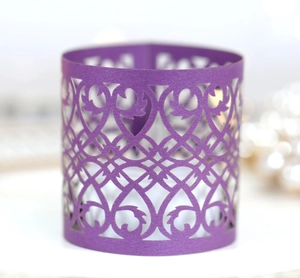 Detailed laser-cut purple hollow heart pattern on decorative LED tea light paper candle wrap