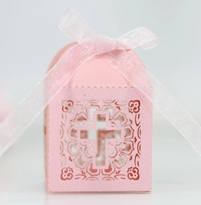 Detailed close-up of pink pearlescent cross hollow favor box with ribbon detail