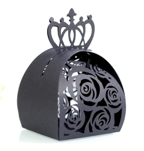 Detail of black laser-cut candy box with floral rose pattern and crown top design