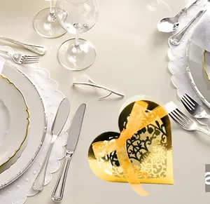 Golden heart-shaped candy box with laser-cut floral patterns and a satin ribbon detail