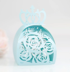 Close-up of light blue laser-cut rose hollow candy box with crown handle for weddings