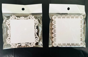 Detailed macro view of laser-cut white lace paper frames for nail art and scrapbooking