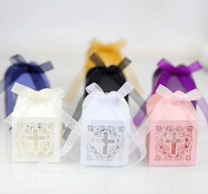Detailed laser-cut floral texture and cross hollow on shimmering pearlescent favor boxes
