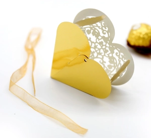 Laser cut heart shaped candy box with gold mirror finish and white floral pattern