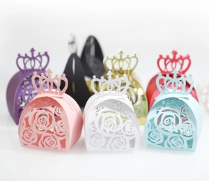Detailed laser-cut crown candy boxes in multiple colors featuring rose flower hollow patterns