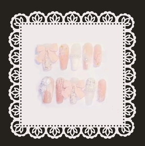 Pink and white handmade press-on nails with 3D bows and pearls on lace card