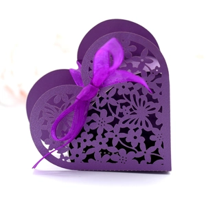 Laser-cut purple heart-shaped gift box with intricate floral patterns and silk ribbon