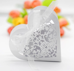 Laser cut white heart candy box with pearl paper floral patterns and white ribbon bow