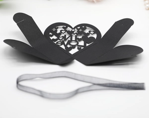 Detailed laser-cut LOVE heart-shaped hollow gift box with elegant black ribbon accessory