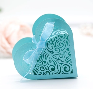 Tiffany blue hollow heart favor box with intricate vine pattern and matching ribbon bow