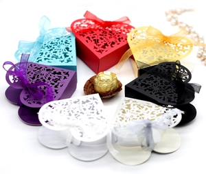 Laser-cut heart-shaped wedding favor boxes with ribbon bows in seven assorted colors