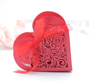 Elegant red heart-shaped laser-cut favor box with decorative ribbon for weddings